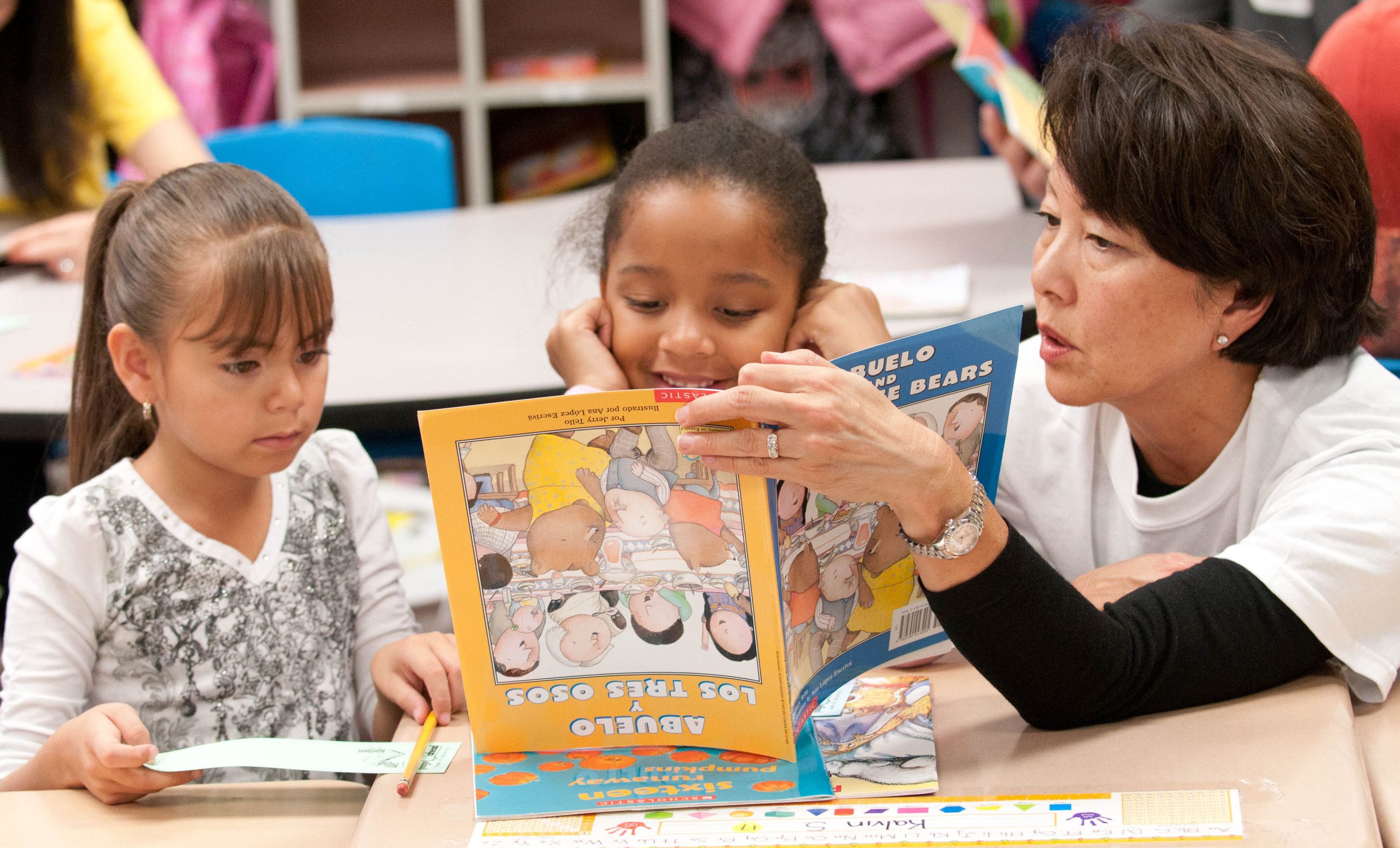 2 girls reading with lady